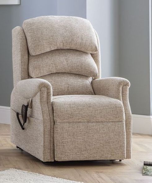 A beige recliner is sitting on a wooden floor in a living room.