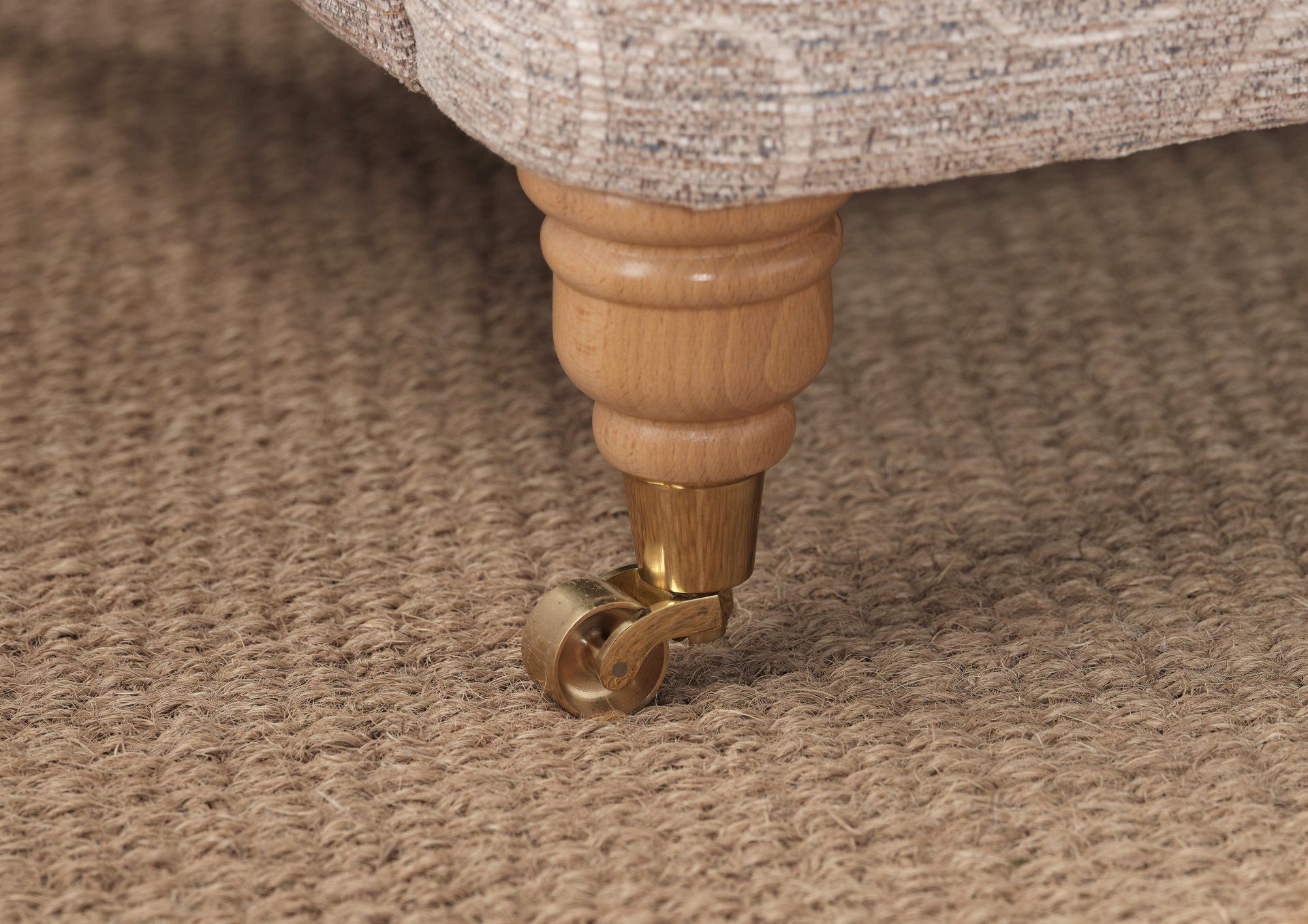 A close up of a chair with wheels on a carpet.
