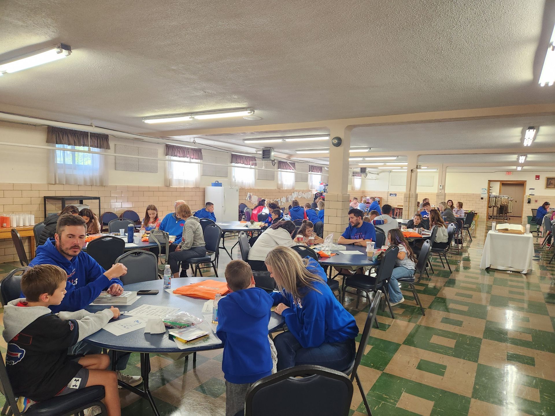 Families at tables during Family Program