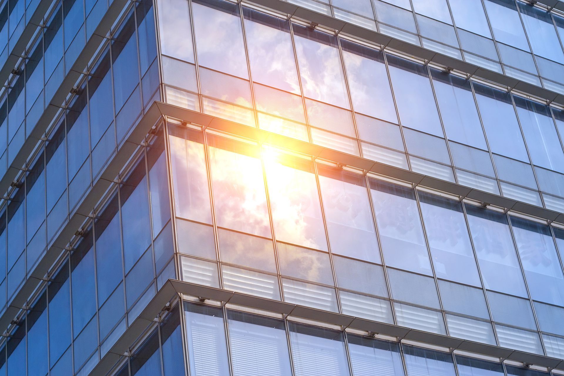 Sunlight reflecting off a modern glass office building facade