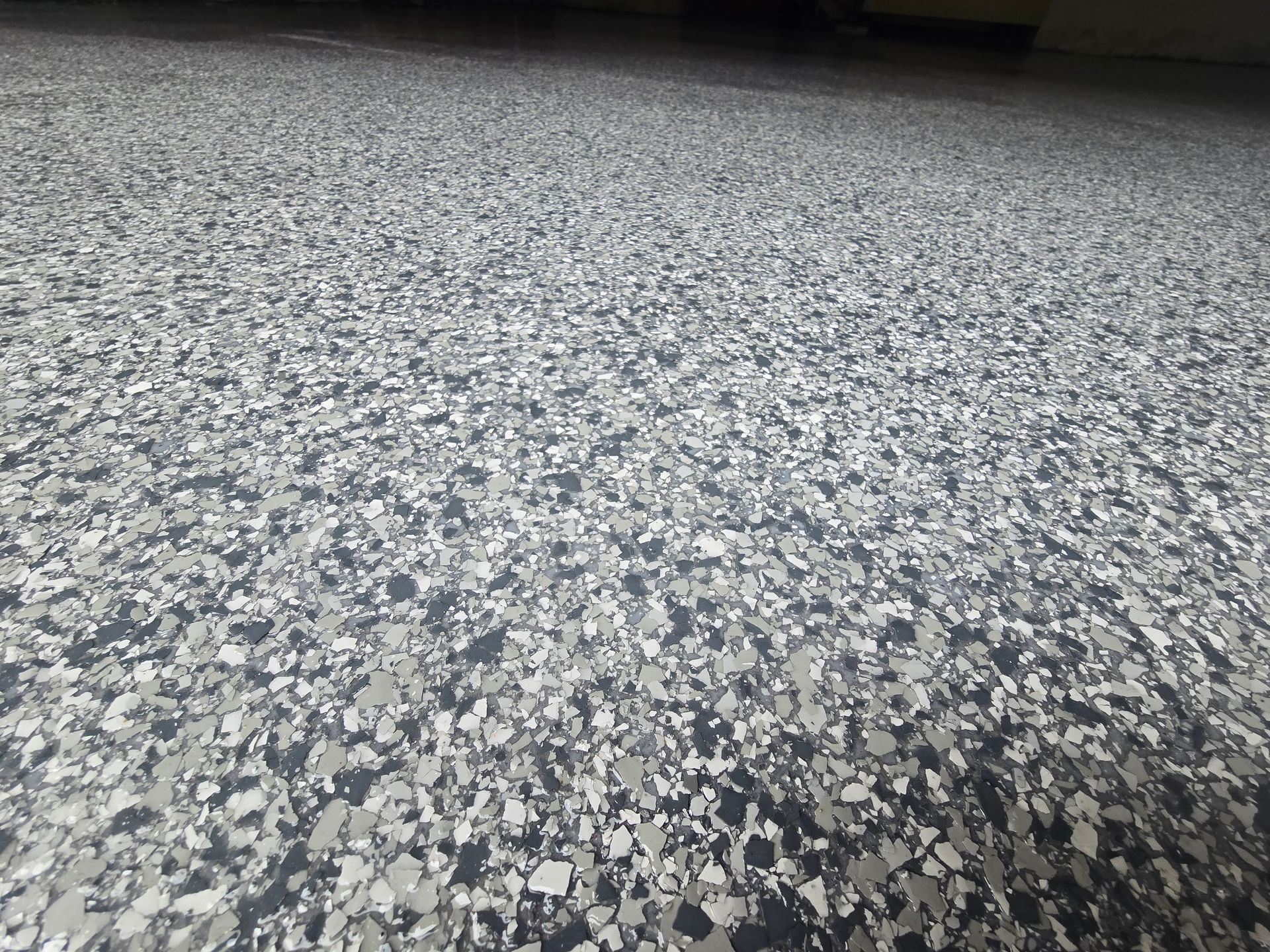 Gray and white speckled epoxy garage floor.