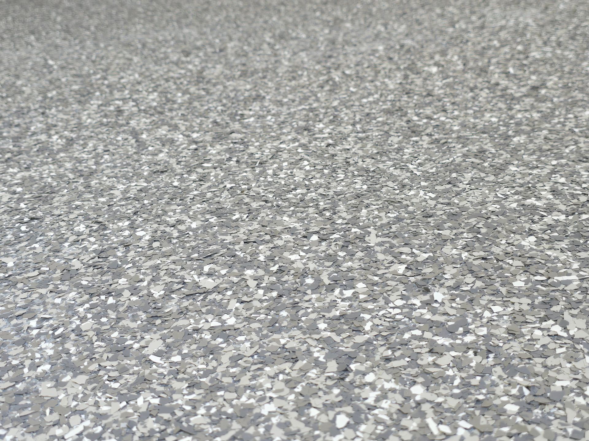 Gray epoxy garage floor with speckled flakes.
