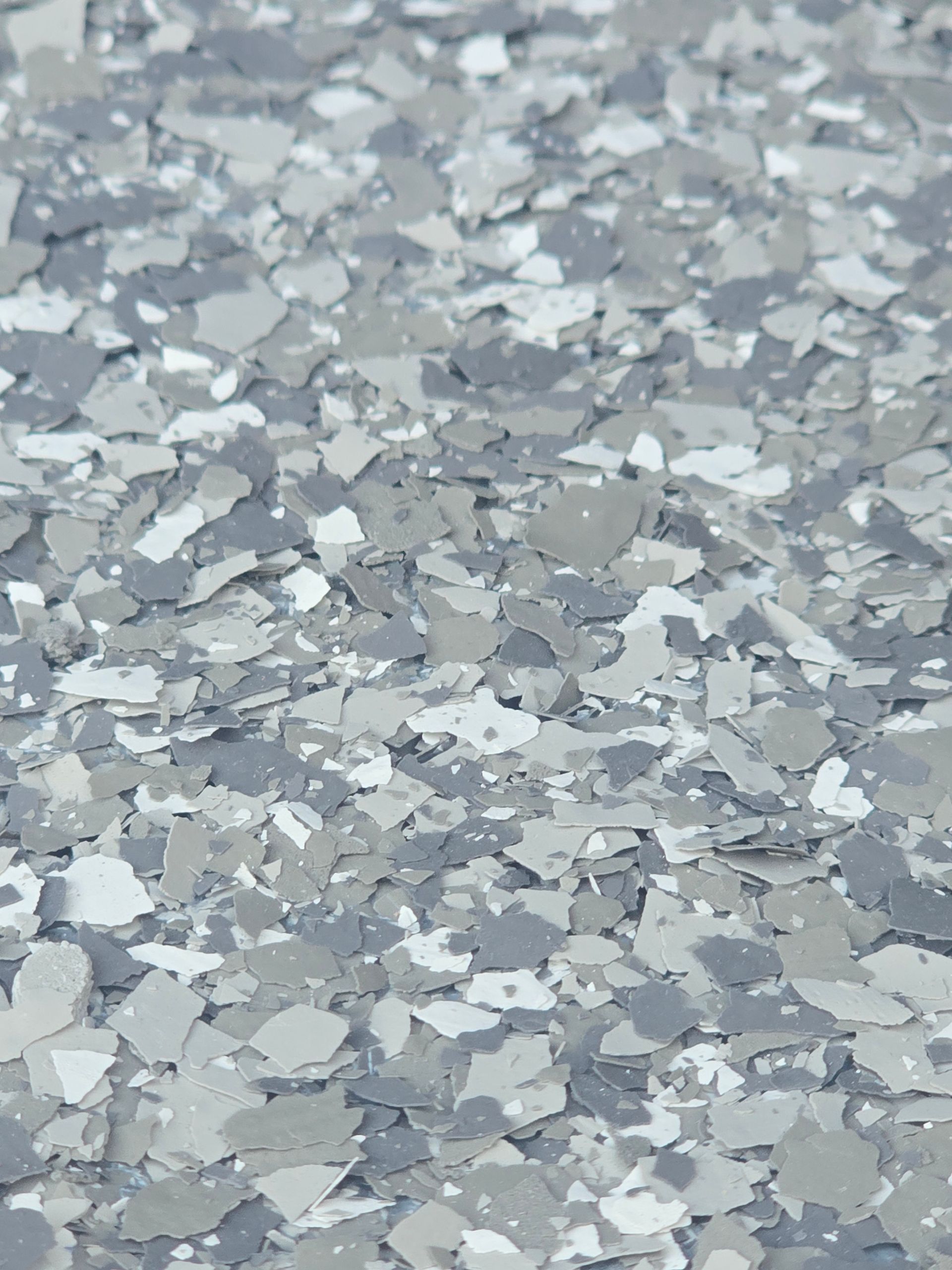 Gray, white, and light gray decorative floor flakes.
