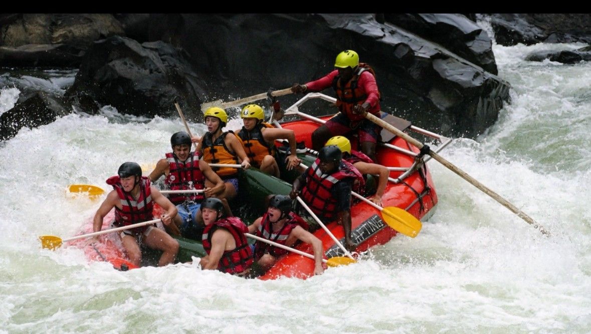 A group of people are rafting down a river.