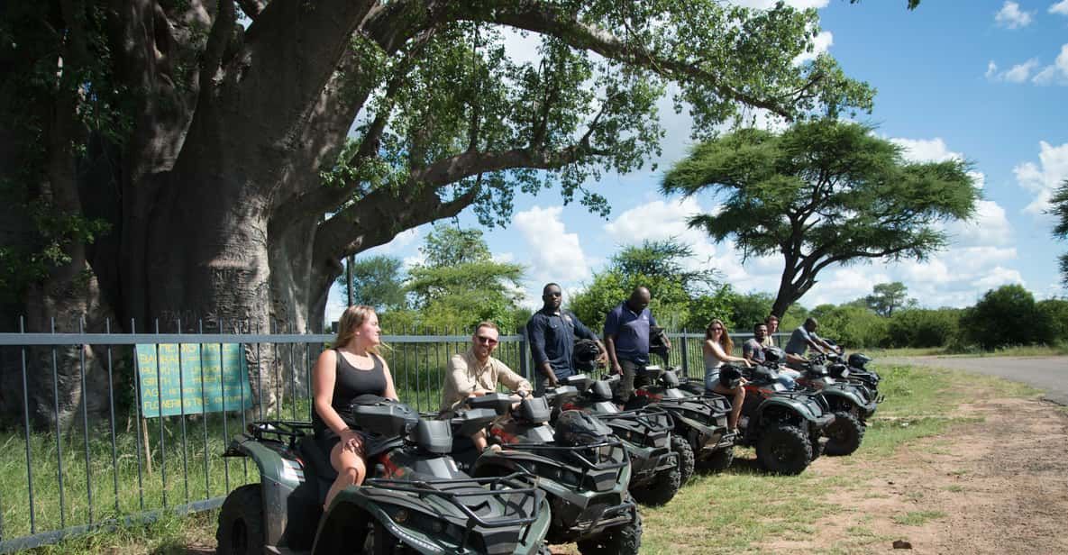 A group of people are riding atvs in a field.