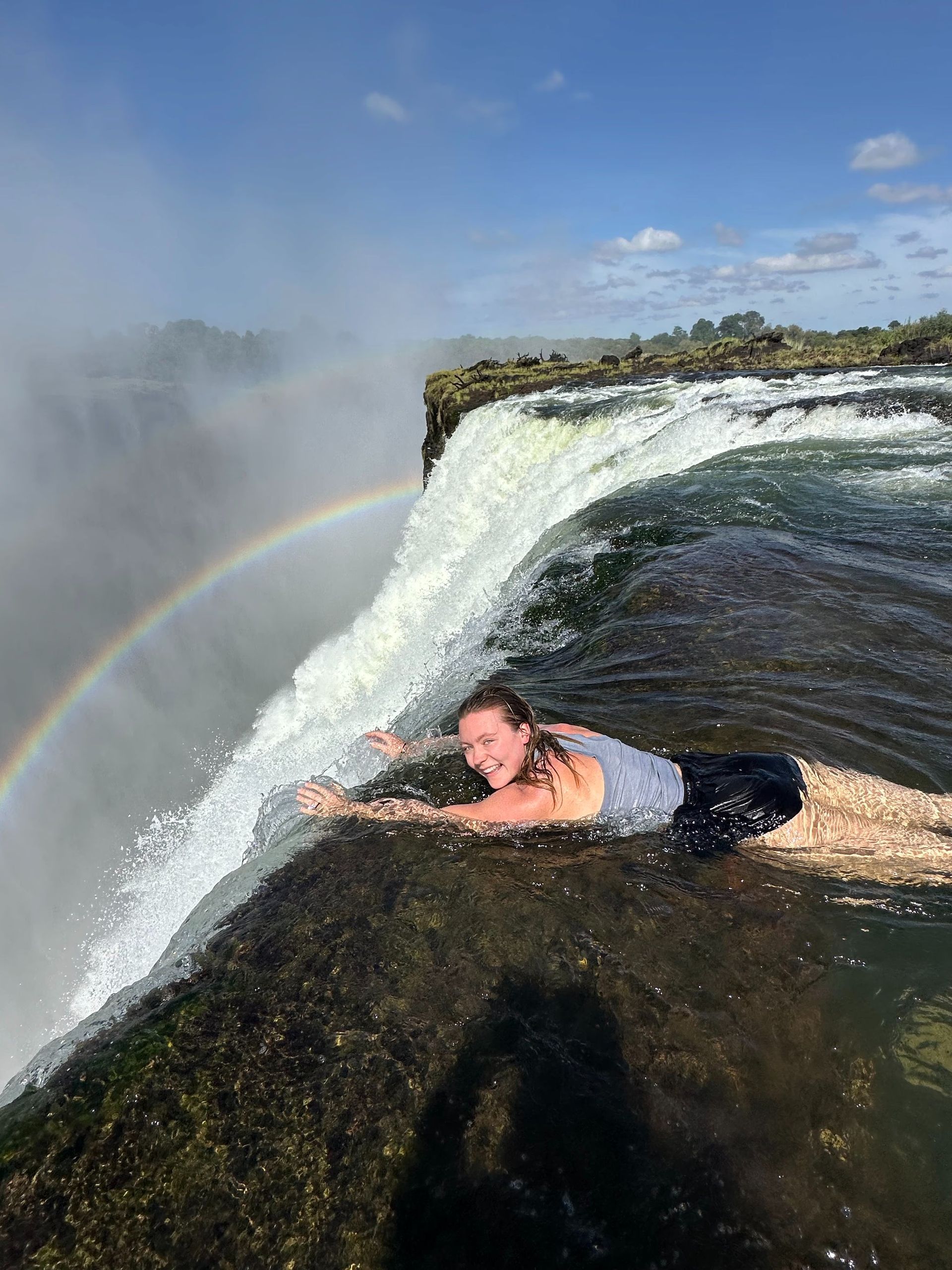 Tourist swimming in Angels Pool Victoria Falls