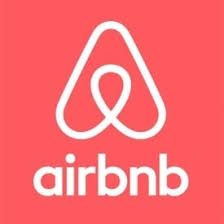 Airbnb logo: white stylized symbol above the word "airbnb" on a gray background.
