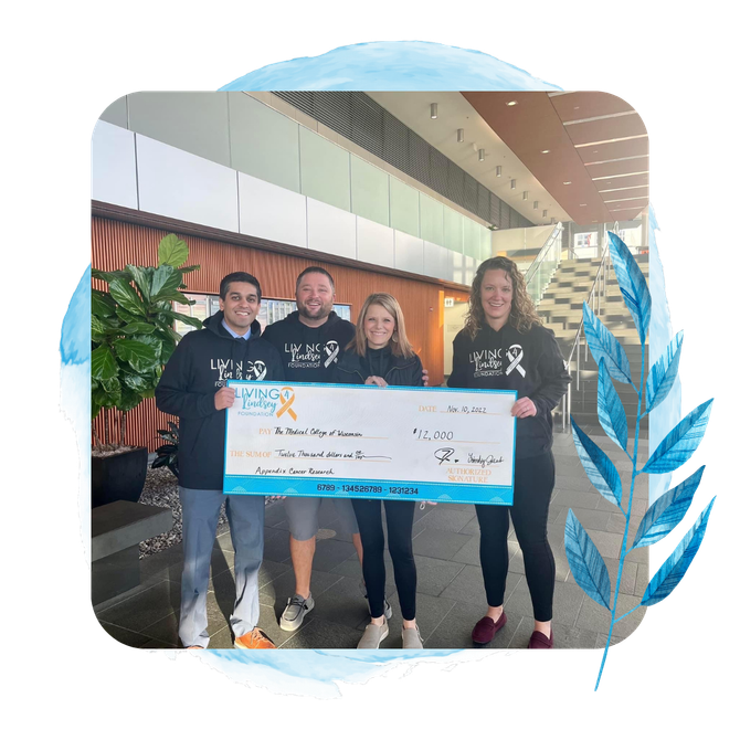a group of people holding a check for $ 12,000