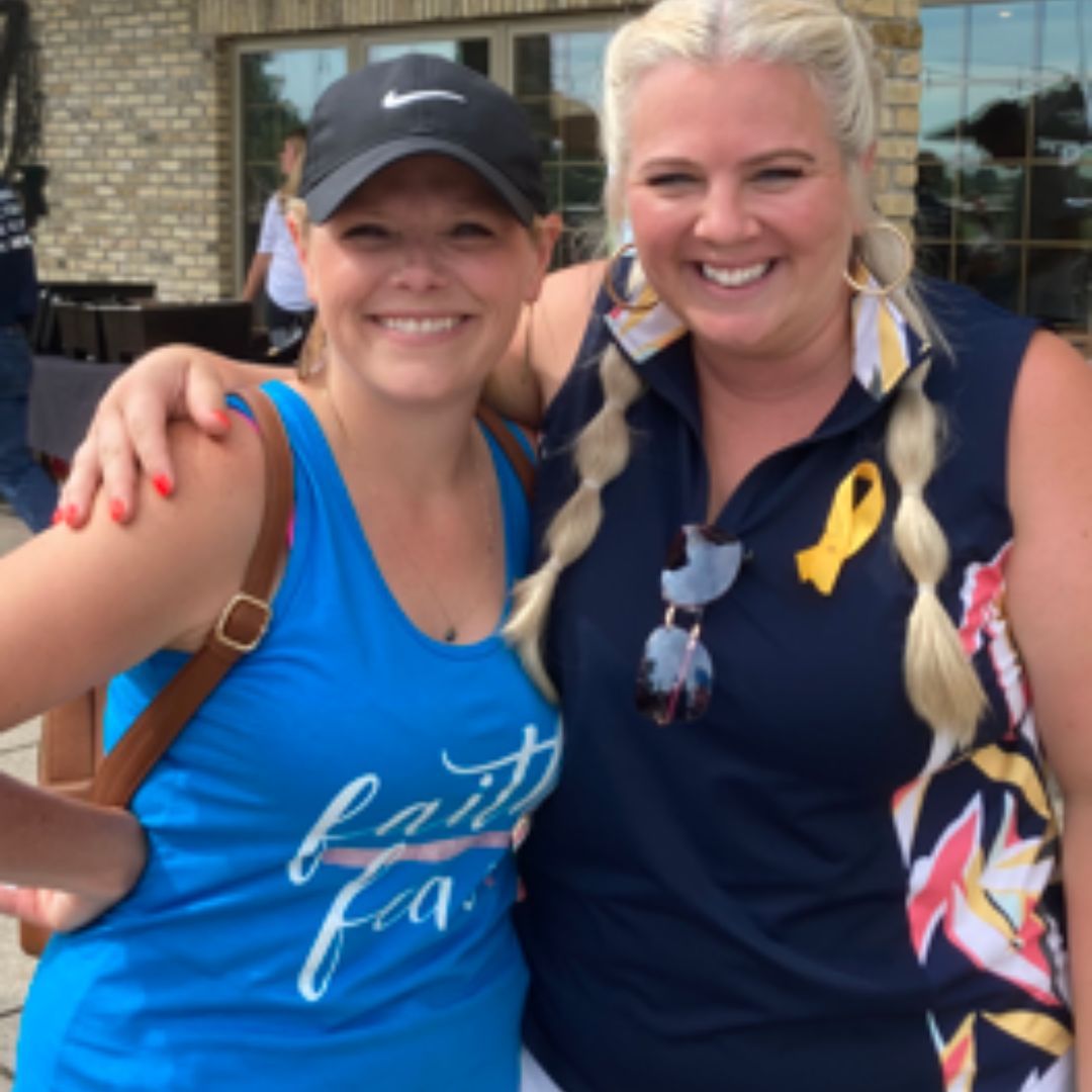 two women posing for a picture one wearing a blue tank top that says faith over fear