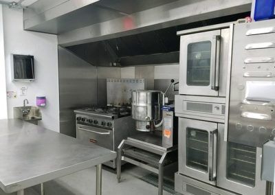 A kitchen with stainless steel appliances and a sink.