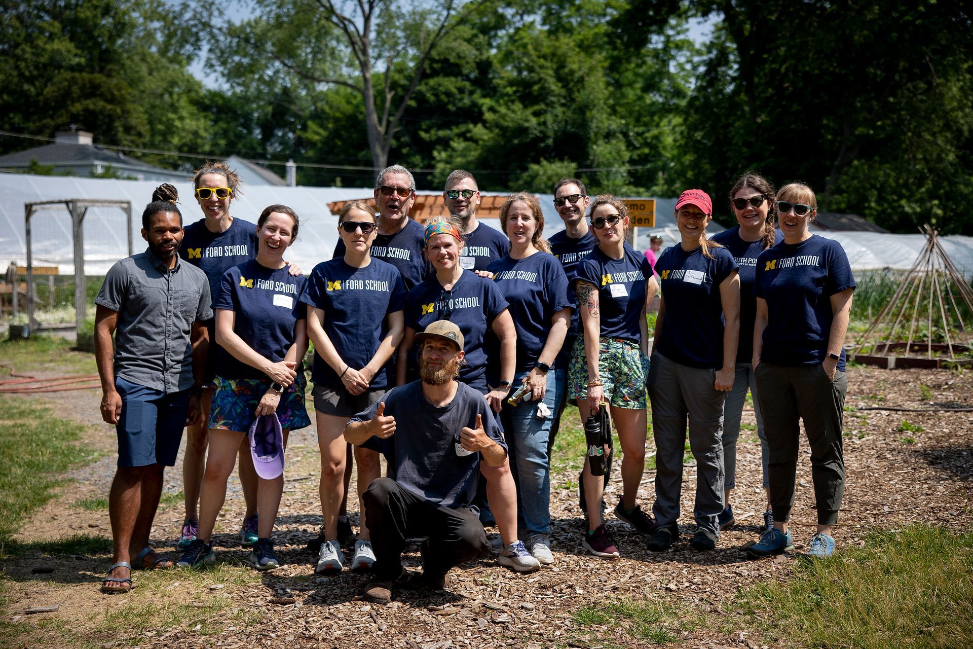 A group of people are posing for a picture in a field.