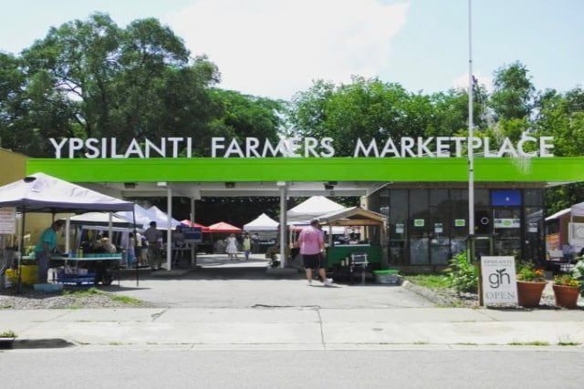 The ypsilanti farmers market is located on the side of the road
