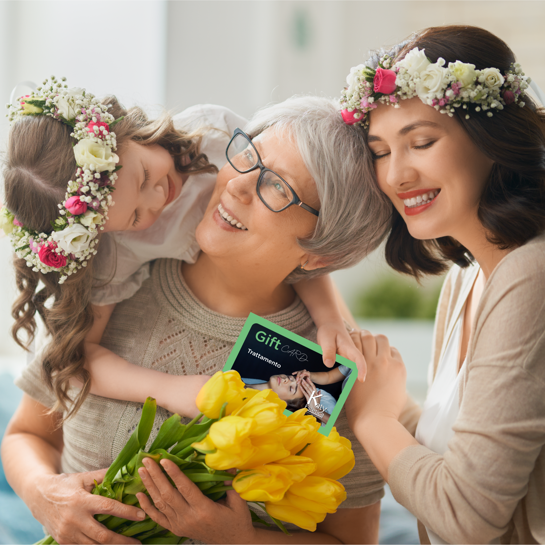 Una bambina che indossa una corona di fiori abbraccia una donna anziana e tiene in mano un biglietto regalo