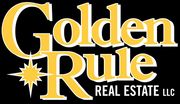 The logo for golden rule real estate llc is yellow and white