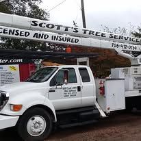 White tree service truck with extended boom; 