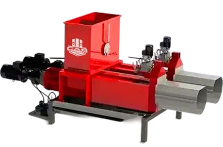 A red industrial briquette press with two stainless steel chutes, used for compressing waste into logs.