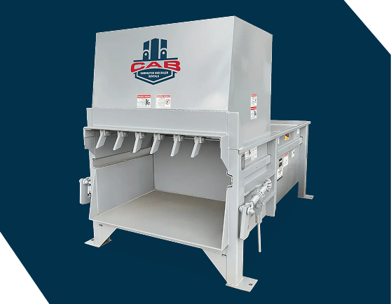 A white industrial trash compactor against a dark blue background with the CAB logo on the side.