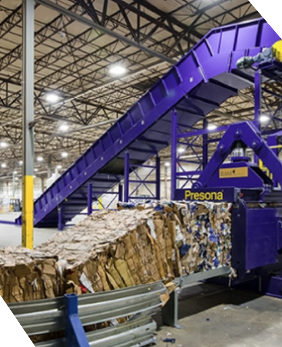 A white industrial trash compactor against a dark blue background with the CAB logo on the side.