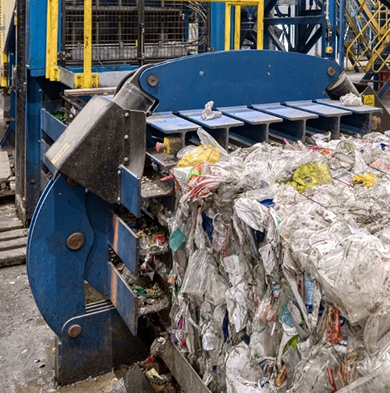 A white industrial trash compactor against a dark blue background with the CAB logo on the side.