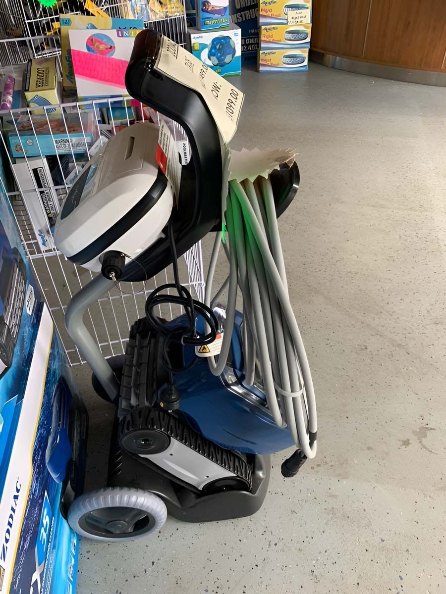 A Swimming Pool Vacuum Cleaner Is Sitting On A Cart In A Store — Pool Zone in Port Macquarie, NSW