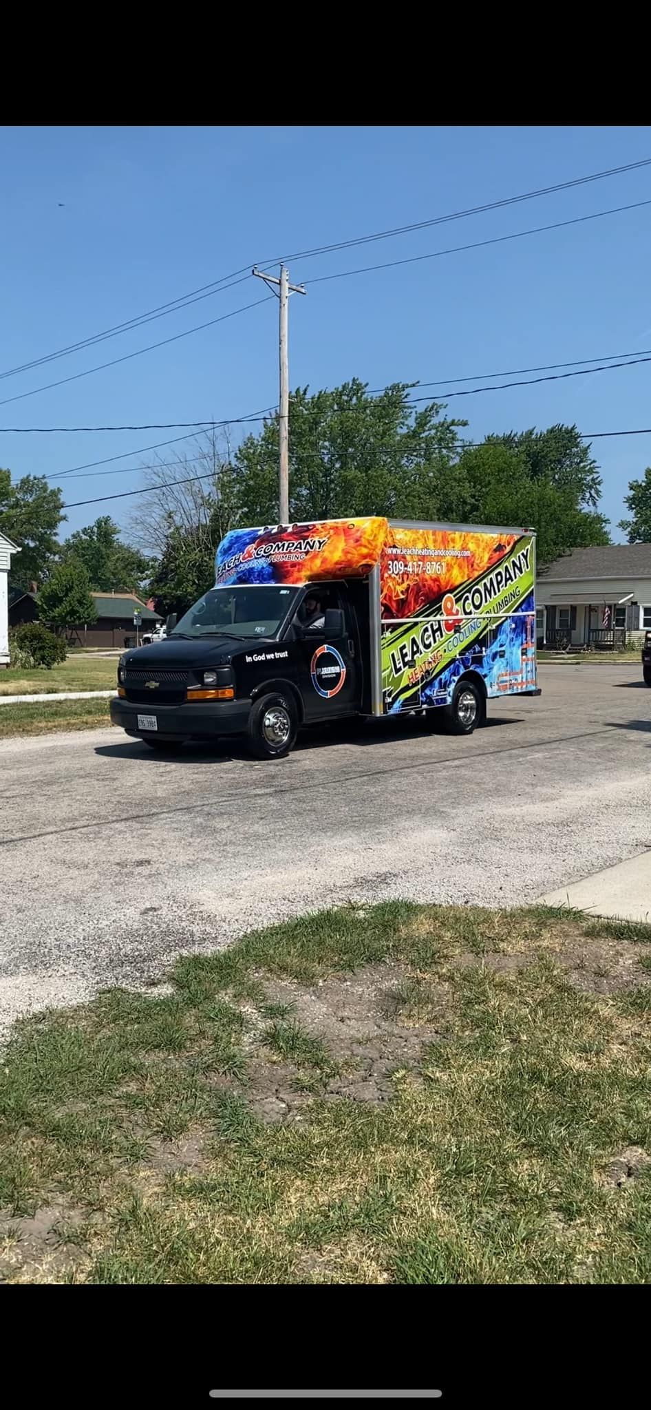 A colorful truck is parked on the side of the road.