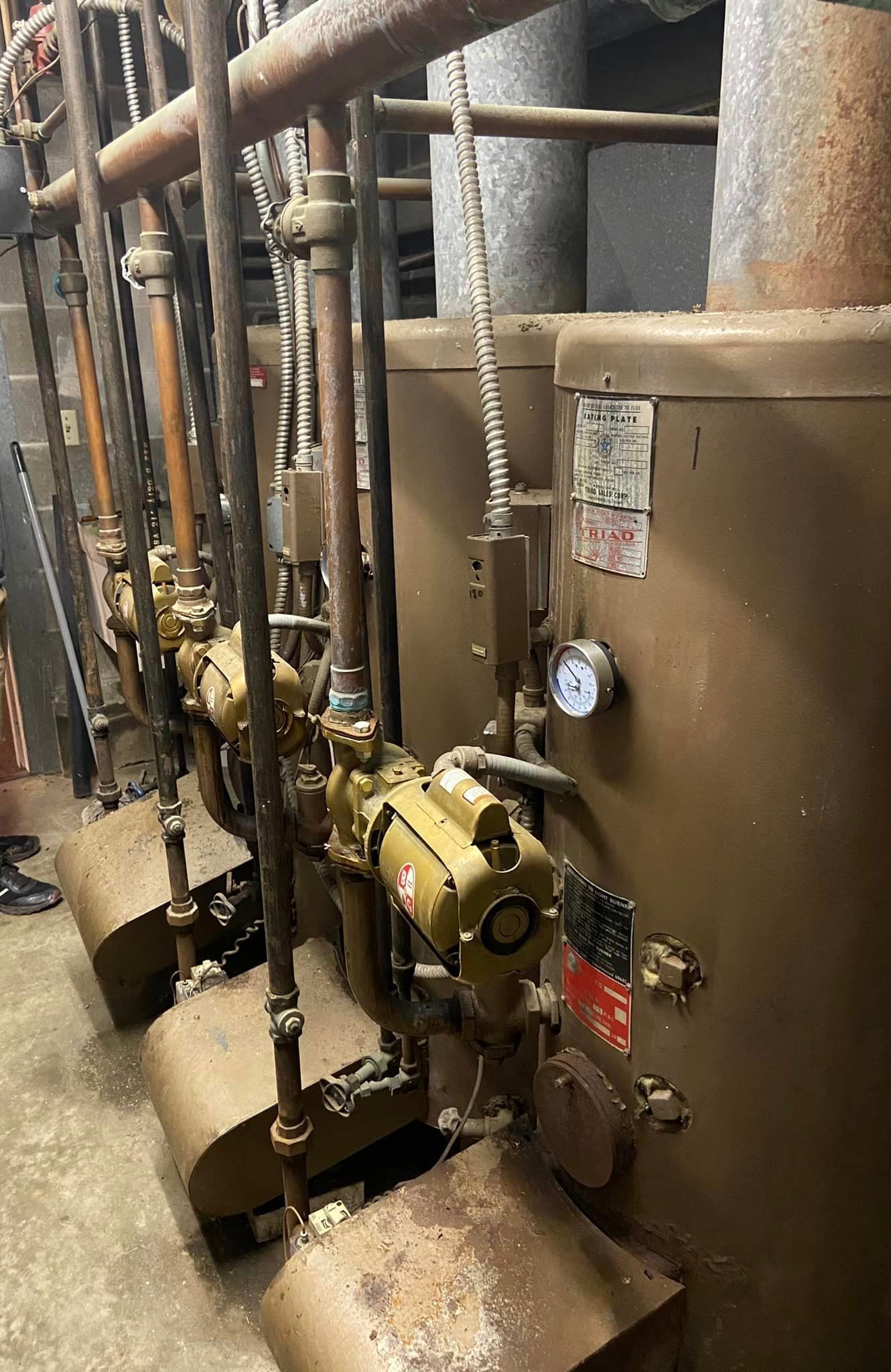 A row of water heaters sitting next to each other in a room.