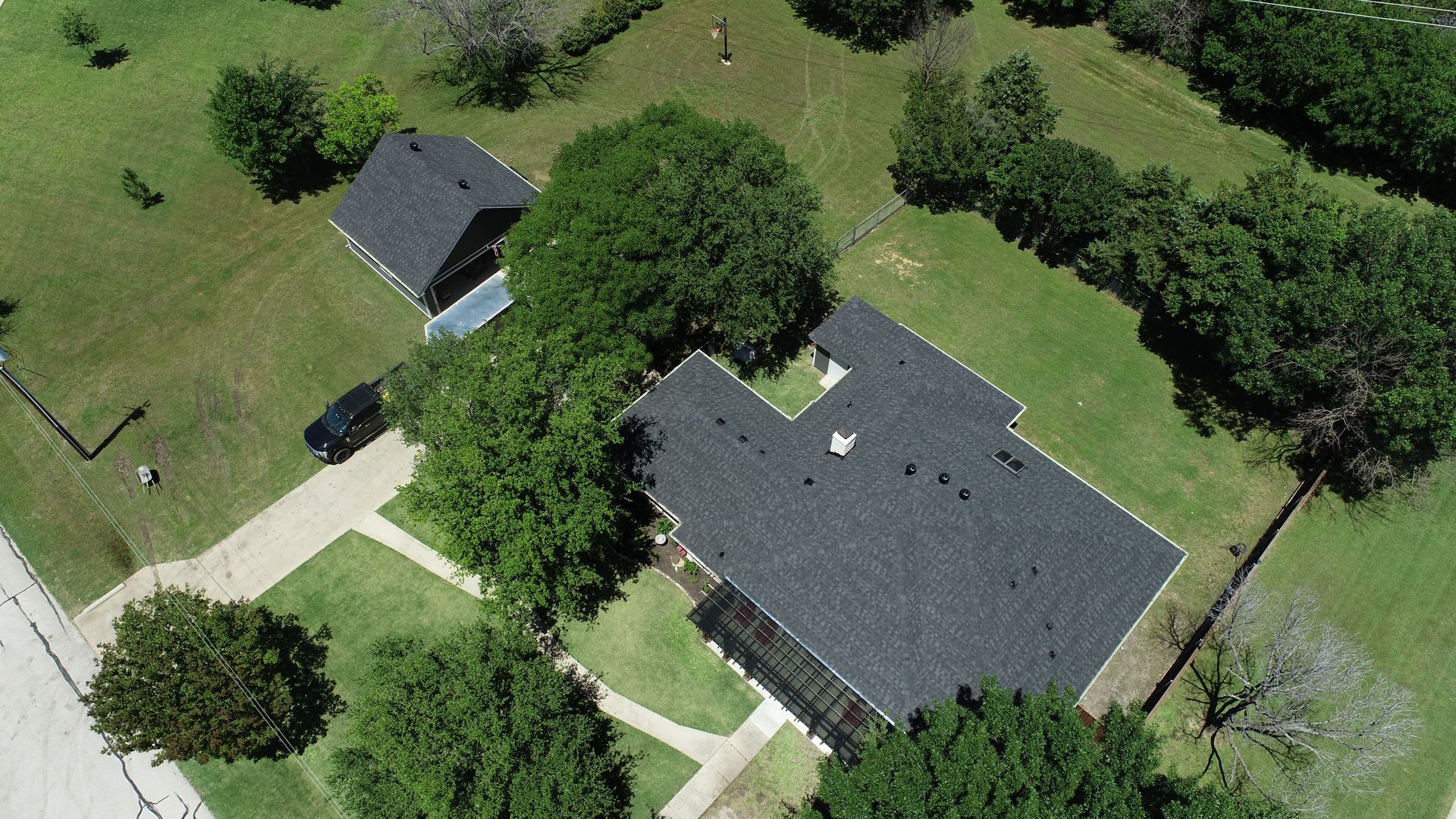 An aerial view of a house with a truck parked in front of it.