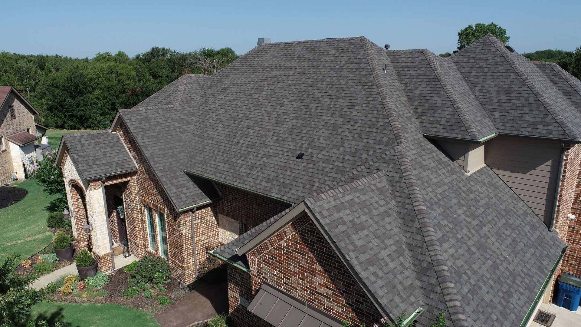 There is a chimney on the roof of a house.