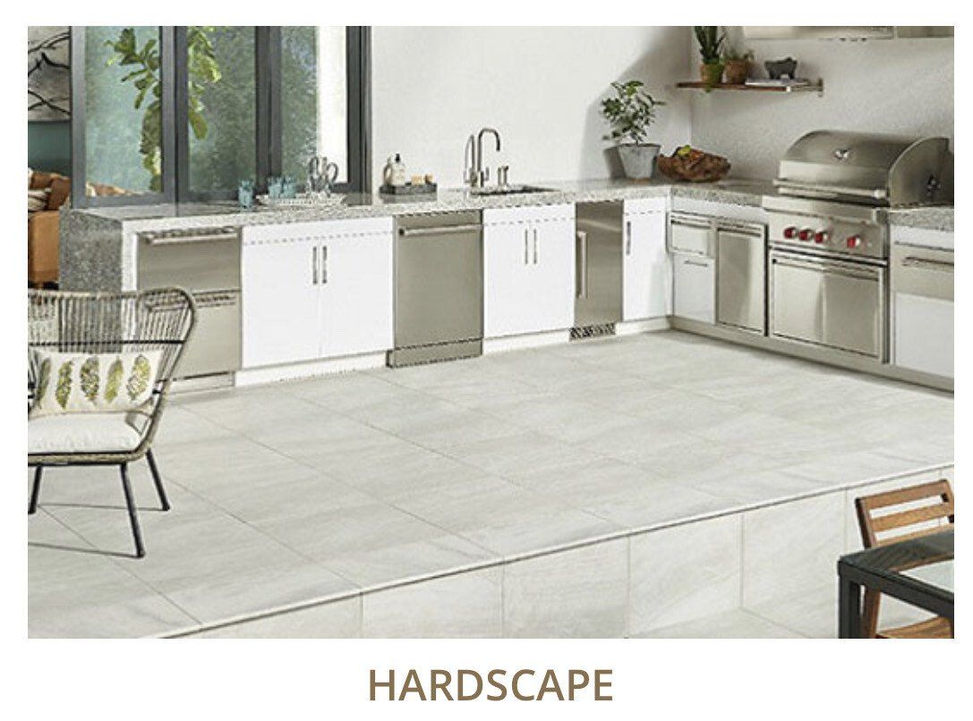 Outdoor kitchen with white cabinets, stainless steel appliances, and gray tiled floor.