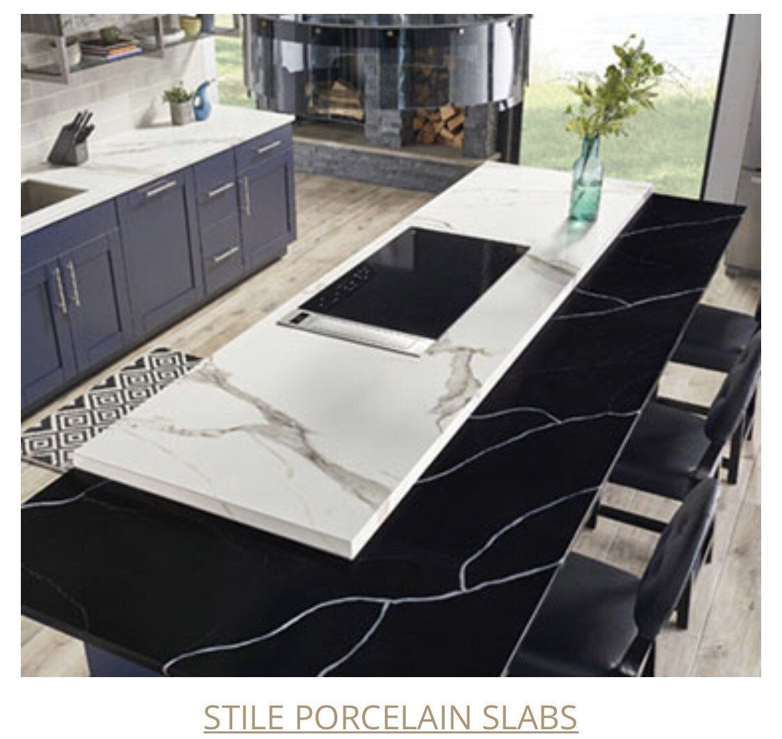 Kitchen island with a white countertop and a black porcelain slab.