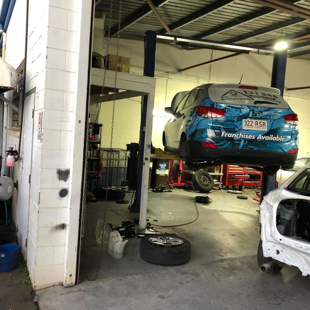 Car Raised On Car Lift — Mechanic In Noosaville, QLD
