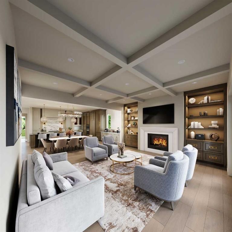 Modern open-concept living room with fireplace, gray sofas, kitchen island, and built-in shelving