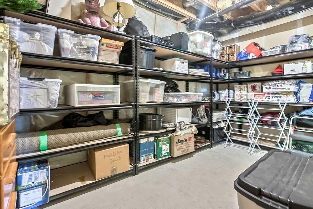 Basement storage shelves packed with bins, boxes, and household supplies