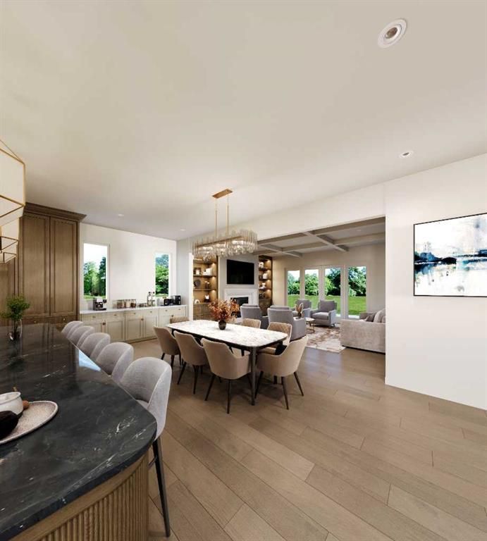 Modern open-plan dining room with large windows, neutral furniture, and a kitchen island