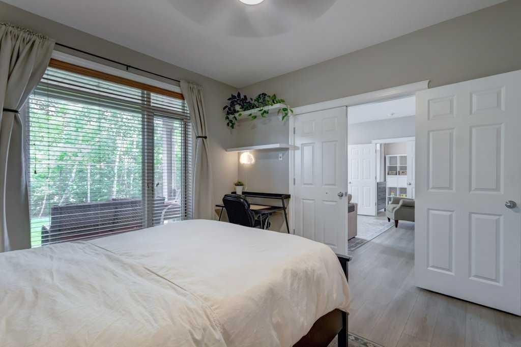 Walk-in closet with wooden drawers, wire shelves, and hanging clothes.