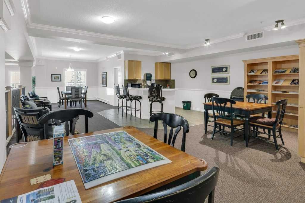 Bright dining room with tables, chairs, and a large wall map in a well-lit open space