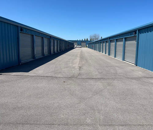 Wide drive-up storage units in Traverse City, MI with roll-up doors and clean paved access lanes at Gorilla Storage Acme.