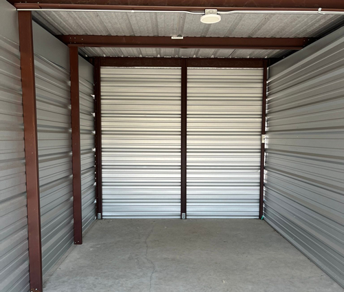 Interior view of a clean, empty storage unit in Traverse City, MI at Gorilla Storage, showing metal walls, concrete flooring, and ample space for household or business storage.