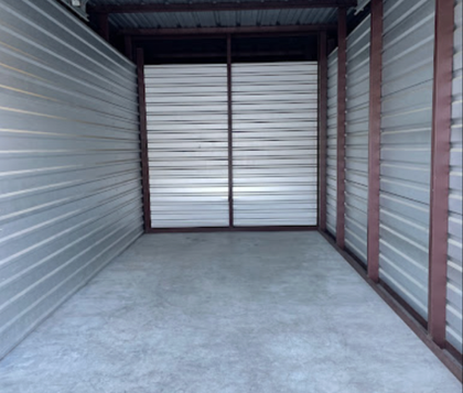Inside view of a drive-up storage unit at Marlin EZ Storage, Marlin TX — clean concrete floor and roll-up door