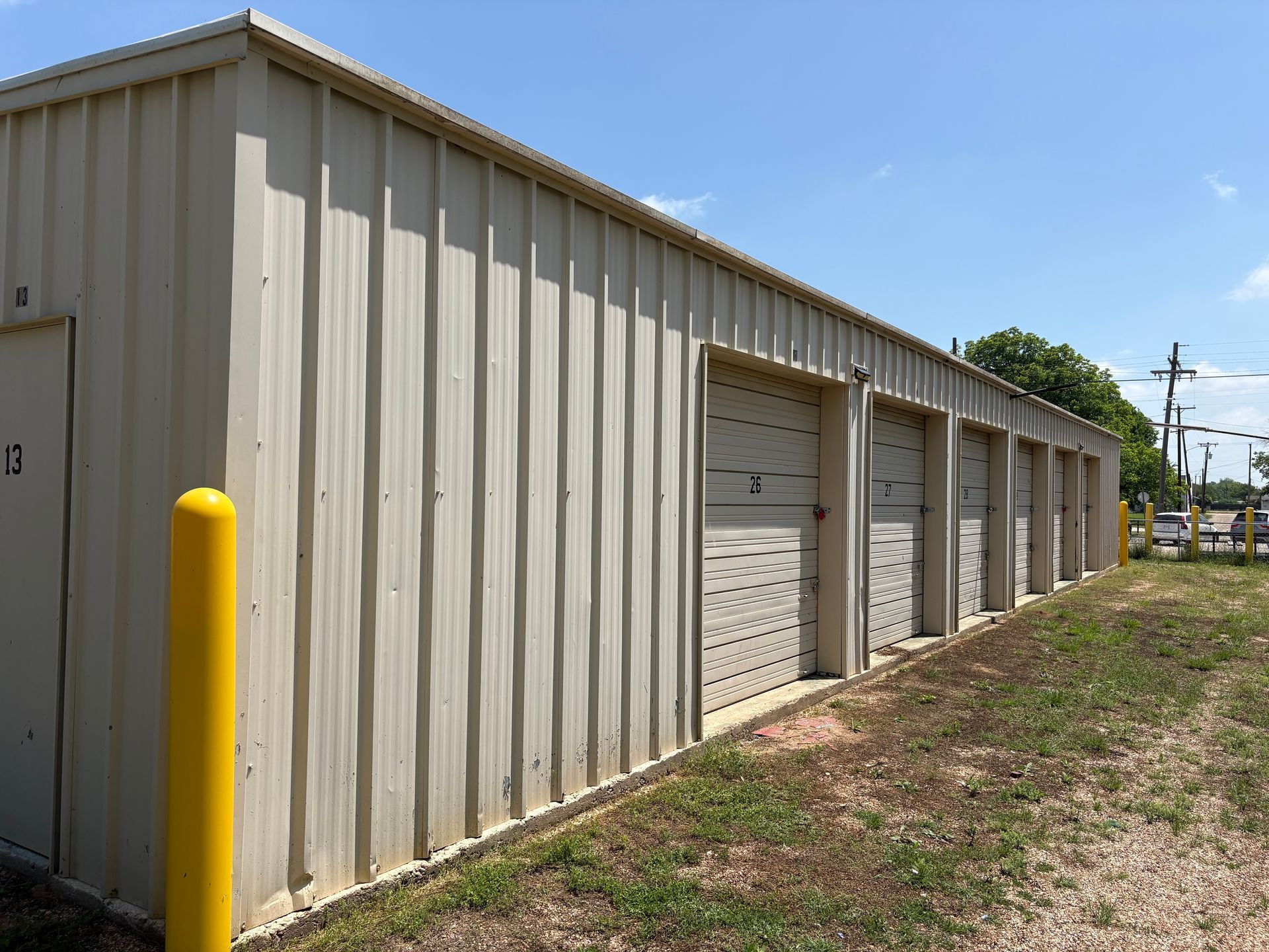 Row of drive-up storage units with roll-up doors at Marlin EZ Storage's Williams Street location in Marlin, TX