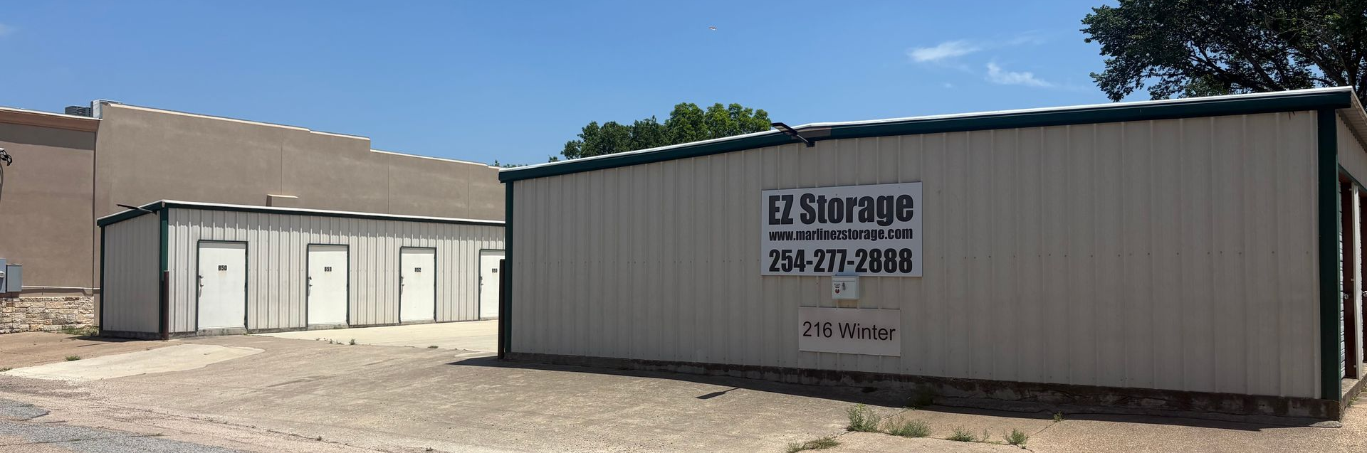 Marlin EZ Storage at 216 Winter Street in downtown Marlin TX showing drive-up unit doors and open parking apron