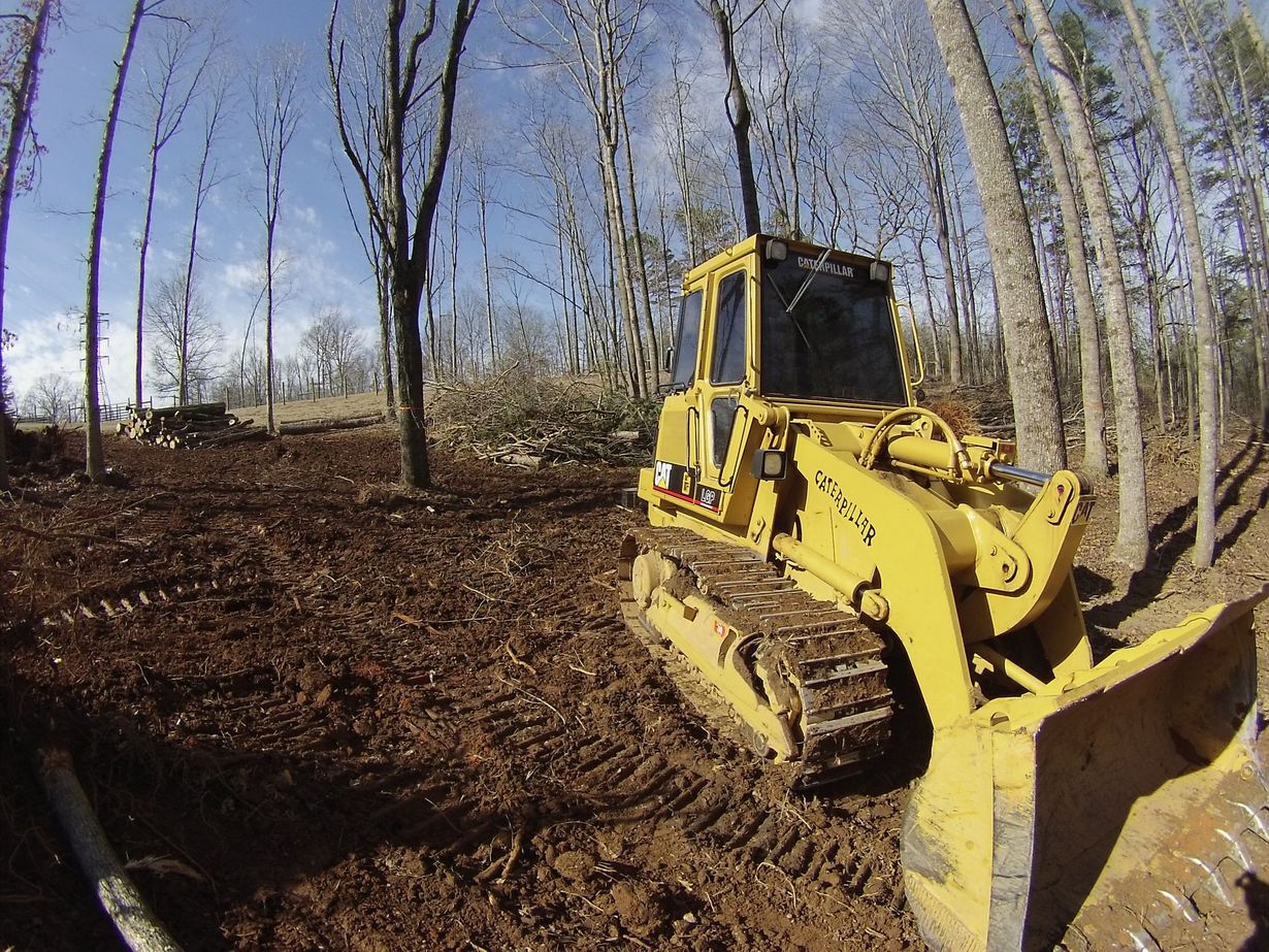 Cat Track Type Loader clearing brush and timber on a North Georgia property