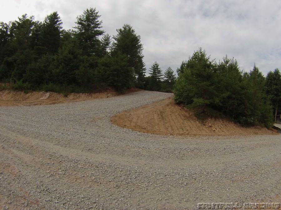 Long gravel driveway winding through North Georgia mountain forest