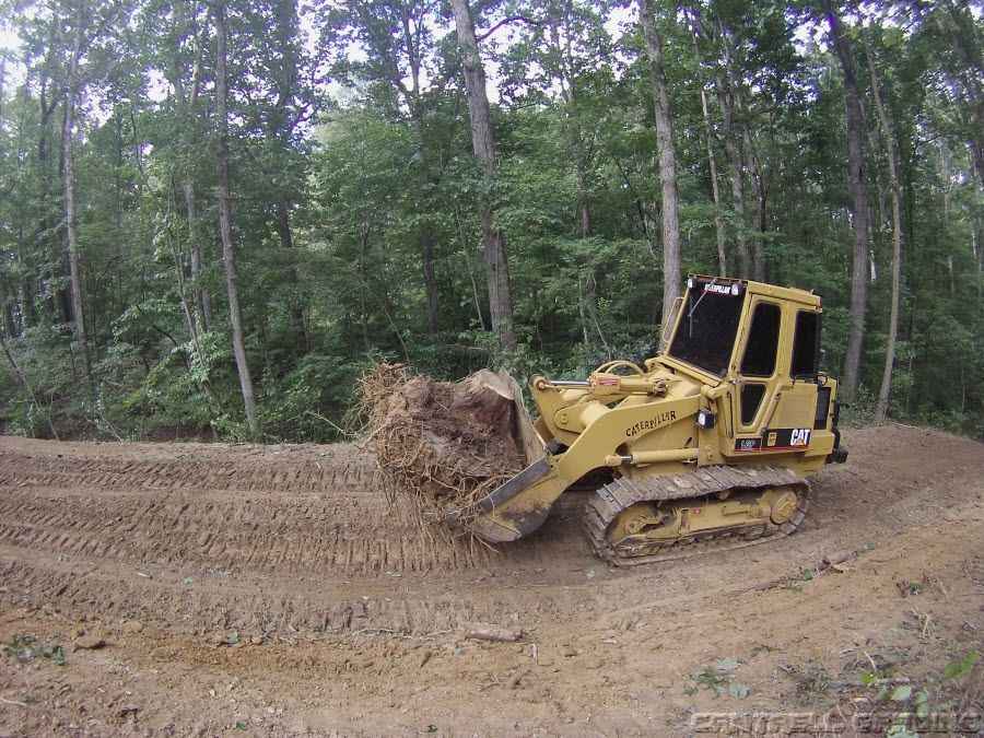 Caterpillar track loader clearing timber and brush on a North Georgia mountain property