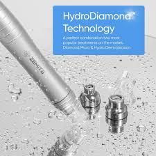 Close-up of a silver skincare device with two interchangeable tips. Blue text indicates “HydroDiamond Technology.”