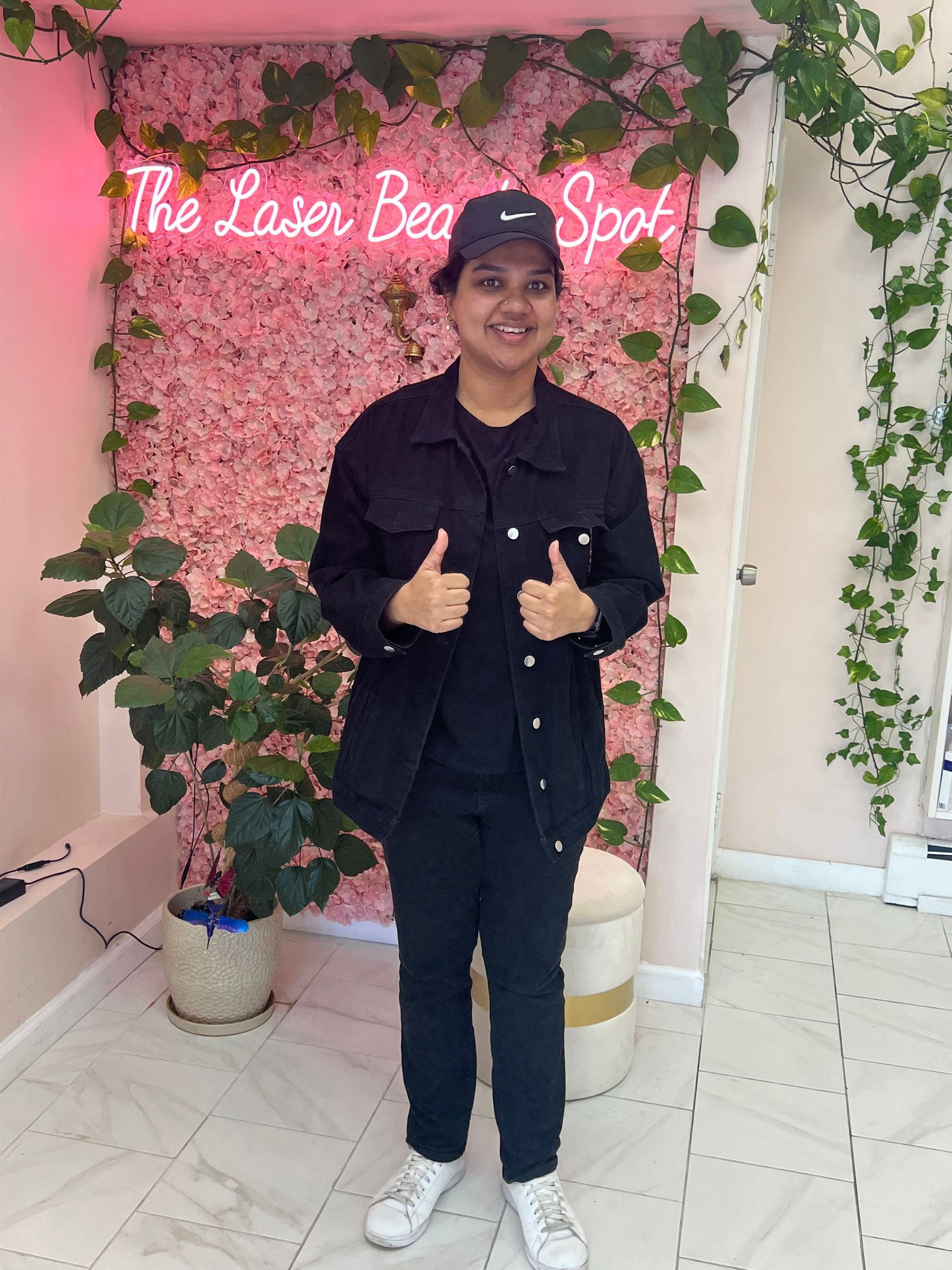 Person in black outfit giving thumbs up at 