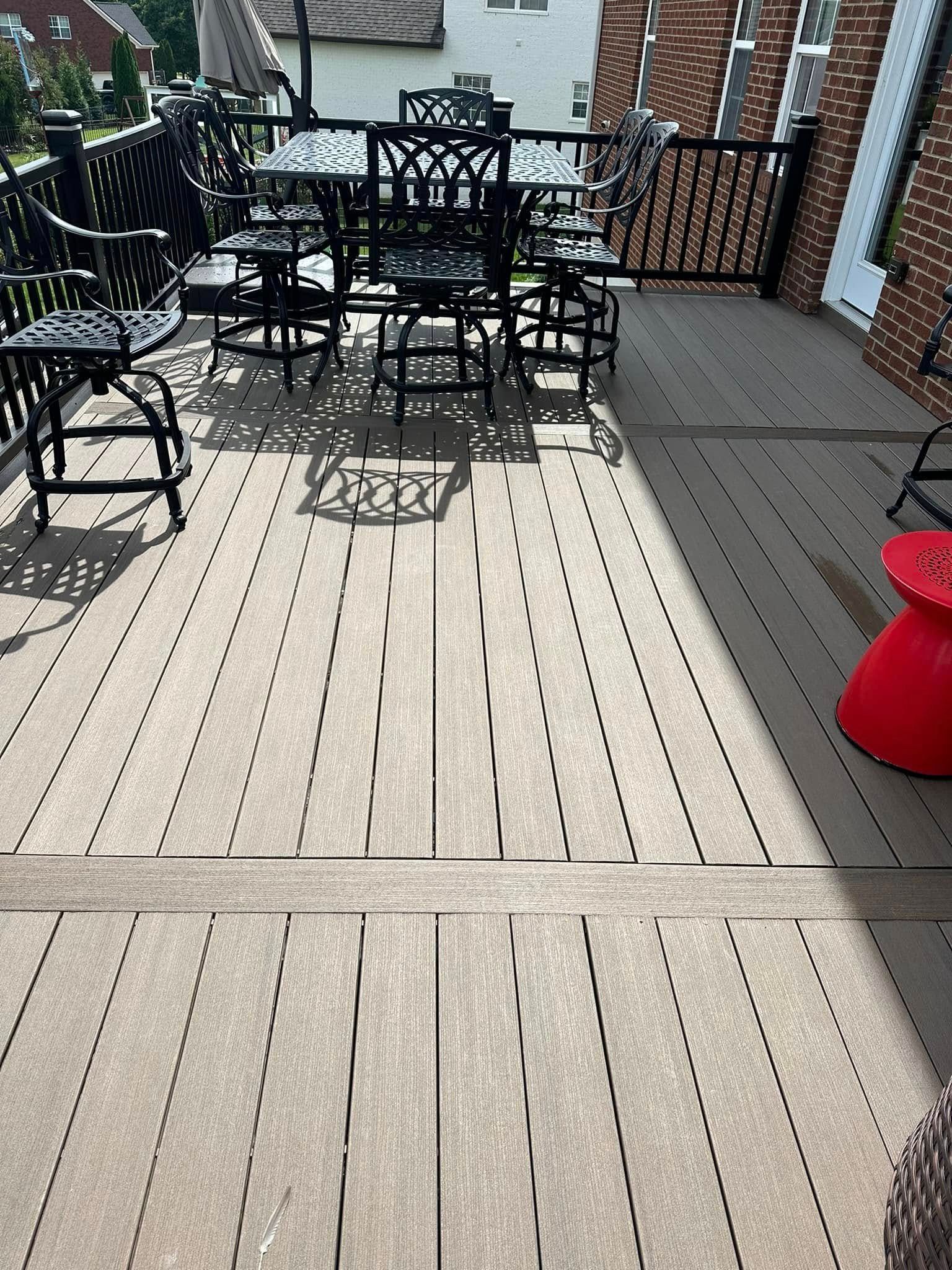 Brown composite deck with outdoor dining furniture.