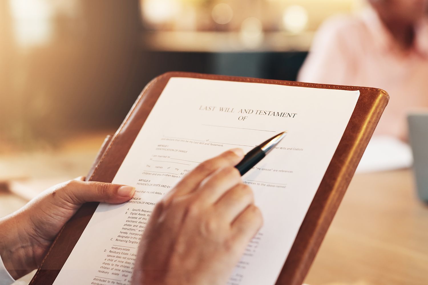 Person pointing with pen at document on wooden clipboard. Person pointing with pen at document on wooden clipboard.