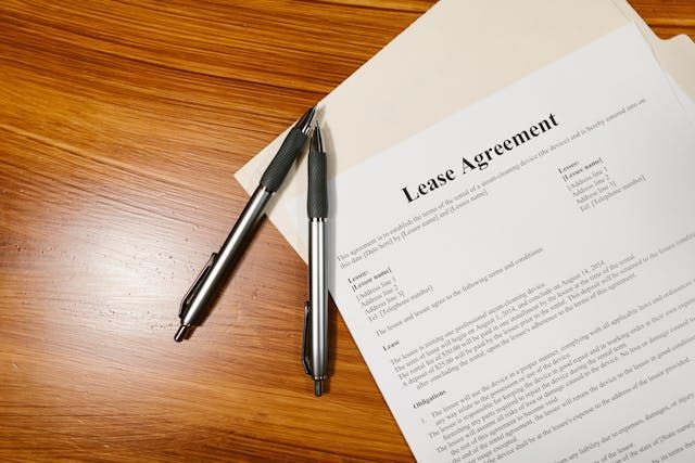 To pens resting on top of a lease agreement