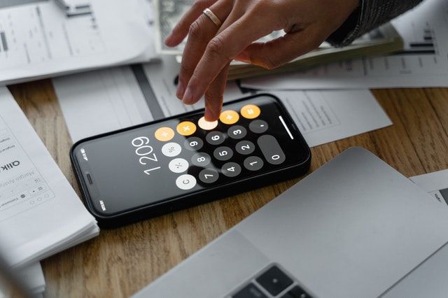 hand putting numbers into a calculator